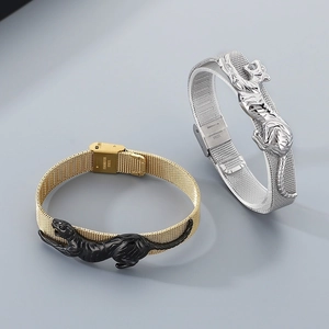 Detail of leopard charm on adjustable stainless steel mesh bracelets in gold and silver