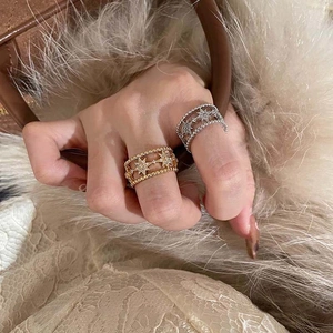 Detail of hollow double-layer star rings in gold and silver with cubic zirconia stones