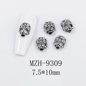 Macro shot of 7.5x10mm retro silver skull nail art charms with white rhinestones