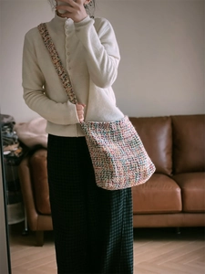 Detail of colorful hand-woven crochet shoulder bag with rich multi-color yarn textures