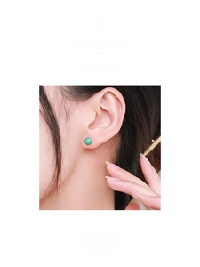 Close-up of S925 sterling silver turquoise stud earring on model's ear for size reference
