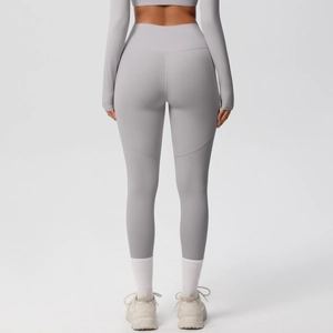 Rear view of light gray high-waisted yoga pants showing lifting and shaping seam details
