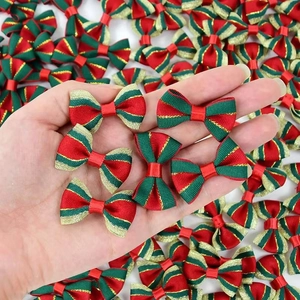 Close-up of handmade red and green Christmas ribbon bows with gold stripes and glossy finish