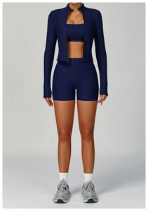 Detailed view of dark blue ribbed yoga set featuring zipper jacket and high waist shorts
