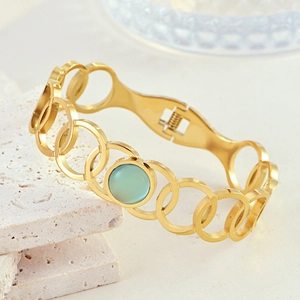 Bohemian gold stainless steel bangle with a green cat-eye stone and hollow round link