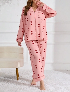 Detail view of pink waffle knit pajama set with red heart patterns and soft texture