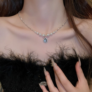Elegant water drop pearl and zircon necklace worn on collarbone with luxury aesthetic