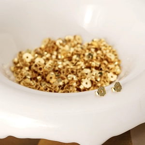 Macro shot of gold-plated 925 sterling silver flower-shaped earring backs with S925 hallmark