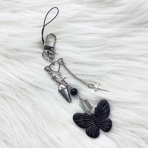 Gothic Y2K butterfly phone charm with silver cross and coffin charms on white fur