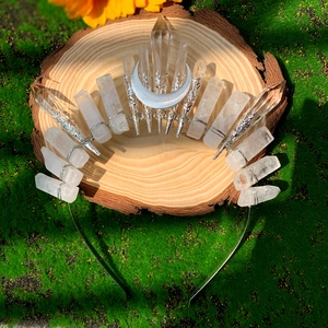 Detailed view of handmade crystal crown with crescent moon on a moss and wooden base