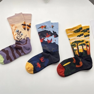 Detailed view of three cotton blend mid-calf socks with colorful graffiti art patterns