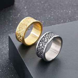 Detail view of woven texture on gold and silver stainless steel rings for men