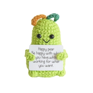 Crochet green pear doll holding an inspirational card for positive desk decoration