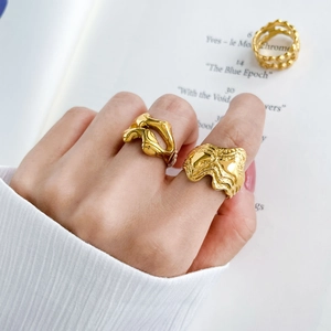 Detail of 18K gold plated fluid lava rings with unique irregular melted metal texture