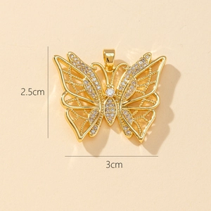Macro shot of 2.5x3cm gold butterfly pendant with crystals and hollow wings detail