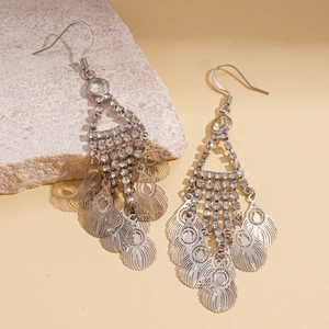 Detailed close-up of bohemian silver drop earrings with rhinestones and hollow leaf tassels