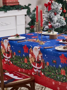 Detail view of festive Christmas tablecloth with Santa and poinsettia prints