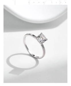 Macro shot of 1 carat square moissanite ring with polished silver 4-prong setting