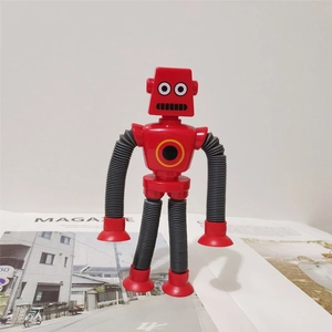 Close-up of red suction cup robot toy with flexible gray telescopic tube limbs and feet