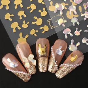 Macro detail of 3D rabbit nail stickers with metallic gold and laser holographic finish