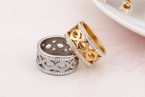 Macro detail of gold and silver steel rings with interlocking circles and pave zircons