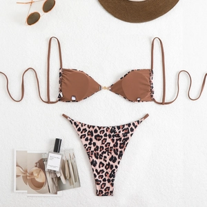 Flat lay of brown bikini top with metal ring and leopard print high-cut bottoms