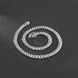 Macro shot of 8mm silver Cuban link chain with S925 stamp on high-quality box clasp