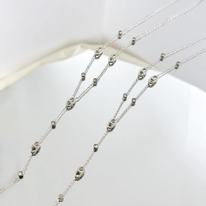 Macro shot of silver pig nose chain links with sparkling zirconia on a sleek necklace