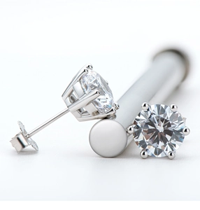 Macro shot of silver stud earrings with classic four-prong and six-prong Moissanite settings