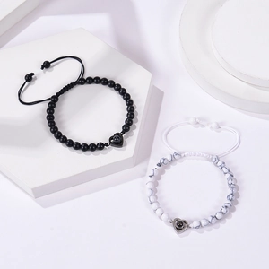 Detail of pink zebra stone bracelets with heart projection stones on geometric stands