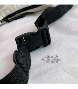 Detail of adjustable black nylon shoulder strap with durable plastic buckle for tote bag