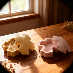 Floral cross resin jewelry storage box mold set in cream and pink on a wooden desk
