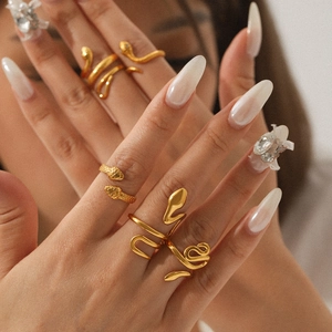 Macro shot of 18K gold snake ring with realistic scale texture on model's hand