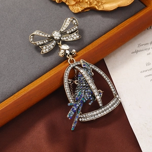 Vintage gold hollow birdcage brooch with colorful crystals and an elegant bowknot