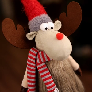Close-up of plush Christmas reindeer toy featuring red knitted hat and faux fur details