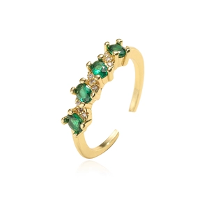 Macro detail of 18K gold plated ring featuring green zircon stones and micro-pave setting