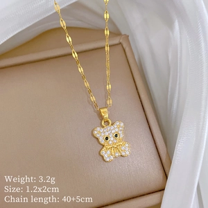 Detailed macro view of a gold bear necklace with cubic zirconia and sizing specifications