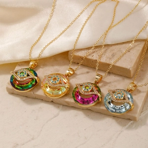 Close-up of evil eye necklaces in various colors on textured stone and silk fabric