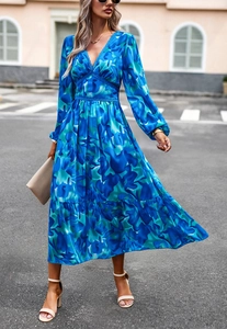 Detail of blue print V-neck maxi dress with waist lace stitching and ruffle hem