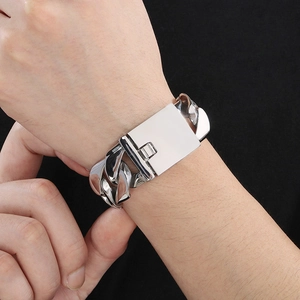 Macro detail of silver 24mm polished stainless steel Cuban chain bracelet for men