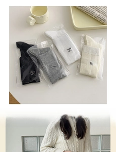Detailed embroidery of bows on knit slouch socks in black, grey, white and cream white