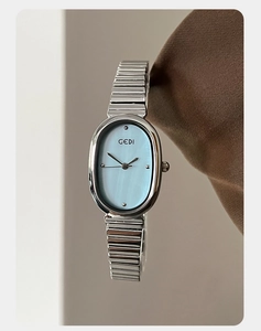 Close-up of GEDI ladies watch with light blue oval dial and silver expansion band