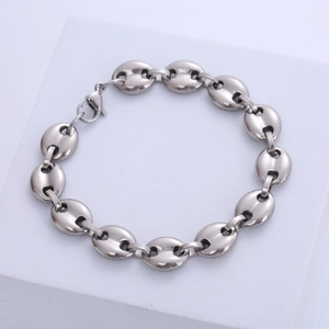 Detailed close-up of silver stainless steel coffee bean chain bracelet with lobster clasp