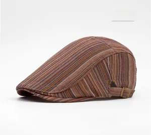 Detail of red striped newsboy hat fabric with metallic side buckle and retro texture