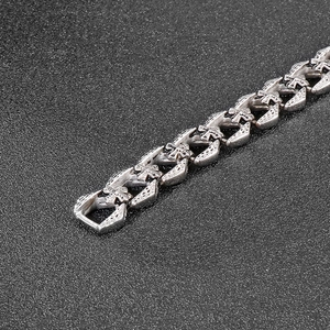 Detail shot of punk retro silver stainless steel bracelet with cross flower chain links