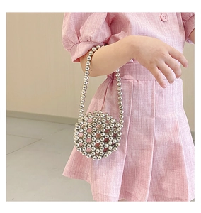 Detail of silver beaded round crossbody bag with metallic pearls for kids and women