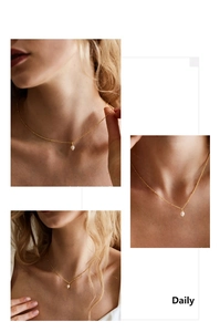 Close-up of elegant gold chain necklace featuring a white pearl pendant for daily wear