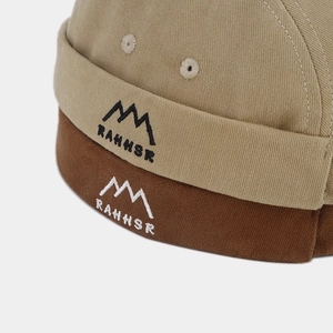 Detailed embroidery of mountain logo and RAHHSR text on cotton docker hats