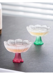 Detailed macro of pink and green frosted glass lotus petal shaped high-stemmed teacups