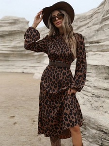 Detail of leopard print maxi dress featuring lantern sleeves and a wide brown buckle belt
